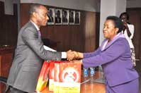 Mrs. Rose Ekawu, Head of Public Enlightenment Unit, EFCC presenting a souvenir to the Chairman, Nigerian Electricity Regulatory Commission, Dr. Sam Amadi after a one day public enlightenment program organized by the EFCC for staff and Management of the Nigerian Electricity Regulatory Commission, NERC recently.  